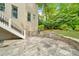 Backyard with a stone patio, stairs, and lush landscaping at 3925 Sheldon Ne Dr, Atlanta, GA 30342