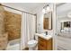 Bathroom showcases a tiled shower, wooden vanity, and modern fixtures in a well-lit space at 3925 Sheldon Ne Dr, Atlanta, GA 30342