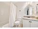 Bathroom with a shower and tub combination, a granite countertop vanity, and an ornate mirror above the sink at 3925 Sheldon Ne Dr, Atlanta, GA 30342