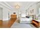 Bright, spacious bedroom with hardwood floors, tray ceilings, and a modern light fixture at 3925 Sheldon Ne Dr, Atlanta, GA 30342