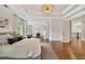 Large bedroom with hardwood floors, tray ceiling, recessed lighting, and access to a sitting room at 3925 Sheldon Ne Dr, Atlanta, GA 30342