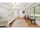 Bedroom features a tray ceiling, hardwood floors and windows providing natural light and outdoor views at 3925 Sheldon Ne Dr, Atlanta, GA 30342
