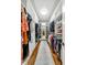 Walk in closet with hardwood floors, custom shelving, and full length mirror at 3925 Sheldon Ne Dr, Atlanta, GA 30342