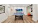 Spacious game room featuring a ping pong table, light hardwood floors, and recessed lighting at 3925 Sheldon Ne Dr, Atlanta, GA 30342