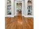 Hallway with hardwood floors, built-in shelving, and view into office creates a sophisticated and functional space at 3925 Sheldon Ne Dr, Atlanta, GA 30342