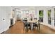 Open kitchen and breakfast nook with white cabinets, island, stainless steel appliances, and access to outdoor area at 3925 Sheldon Ne Dr, Atlanta, GA 30342