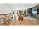 Spacious living room with wood floors, built-in cabinets, a comfortable couch, and plenty of natural light from the backyard at 3925 Sheldon Ne Dr, Atlanta, GA 30342