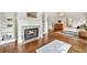 Living room with hardwood floors, fireplace with white mantle, and built in shelves at 3925 Sheldon Ne Dr, Atlanta, GA 30342