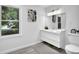 Modern bathroom featuring floating vanity, decorative mirror, and wood-look flooring at 82 Vanessa Se Dr, Smyrna, GA 30082