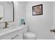 Elegant half bathroom features a white vanity with a marble countertop and modern fixtures at 82 Vanessa Se Dr, Smyrna, GA 30082