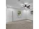 Bedroom featuring neutral carpeting, large window, and ceiling fan at 82 Vanessa Se Dr, Smyrna, GA 30082