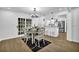 Bright dining area features wood floors, modern chandelier, and access to a modern kitchen at 82 Vanessa Se Dr, Smyrna, GA 30082