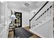 Inviting foyer showcases a black door, hardwood floors, stairs with white banister and black rails at 82 Vanessa Se Dr, Smyrna, GA 30082