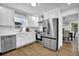 Modern kitchen boasts stainless steel appliances, white cabinets, and subway tile backsplash at 82 Vanessa Se Dr, Smyrna, GA 30082