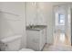 Bathroom with granite countertop, toilet and doorway to a bedroom with natural light at 943 Peachtree Ne St # 716, Atlanta, GA 30309