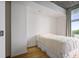 Cozy bedroom with hardwood floors and white walls at 943 Peachtree Ne St # 716, Atlanta, GA 30309
