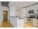 This kitchen has white cabinets, stainless steel appliances, granite countertops, and hardwood floors at 943 Peachtree Ne St # 716, Atlanta, GA 30309