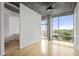 Bright living room with floor to ceiling windows and hardwood floors with views of the bedroom at 943 Peachtree Ne St # 716, Atlanta, GA 30309