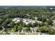 Aerial view of neighborhood, showing the school, homes, and surrounding trees at 221 Brooke Dr., Alpharetta, GA 30009