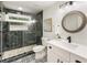Modern bathroom featuring a glass-enclosed shower with tile, updated fixtures, and decorative floor tiles at 221 Brooke Dr., Alpharetta, GA 30009