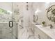 This spacious bathroom features marble flooring, a glass shower, and sleek white cabinets at 221 Brooke Dr., Alpharetta, GA 30009