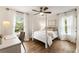 Comfortable bedroom with a four poster bed, wood floors and bright natural light at 221 Brooke Dr., Alpharetta, GA 30009