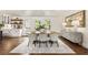 Open dining area adjacent to kitchen, featuring a large table and natural light from backyard views at 221 Brooke Dr., Alpharetta, GA 30009
