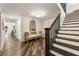 Inviting entryway showcasing stairs with wood treads, dark balusters, and a seating area with a decorative mirror at 221 Brooke Dr., Alpharetta, GA 30009