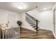 Spacious entryway featuring dark wood stairs with dark balusters and a sitting area at 221 Brooke Dr., Alpharetta, GA 30009