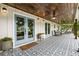 Inviting front porch with blue doors, decorative tile flooring, and comfortable seating at 221 Brooke Dr., Alpharetta, GA 30009