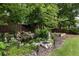 Backyard garden featuring a tranquil water feature, decorative rocks, and lush plantings at 221 Brooke Dr., Alpharetta, GA 30009