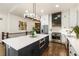 Bright kitchen with large island with stainless steel appliances, and access to staircase and kitchen sink at 221 Brooke Dr., Alpharetta, GA 30009