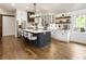 This gourmet kitchen offers stainless steel appliances, a large island, white cabinets and hardwood flooring at 221 Brooke Dr., Alpharetta, GA 30009