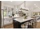 Open-concept kitchen with stainless steel appliances, island with seating, and a view into the dining room at 221 Brooke Dr., Alpharetta, GA 30009