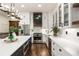 Spacious kitchen featuring a large island, stainless steel appliances, and access to the staircase and kitchen sink at 221 Brooke Dr., Alpharetta, GA 30009
