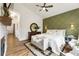 This main bedroom suite offers stylish decor with an elegant accent wall and contemporary hardwood flooring at 221 Brooke Dr., Alpharetta, GA 30009