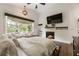 This bedroom showcases a cozy fireplace, bright windows, and a large flat screen TV at 221 Brooke Dr., Alpharetta, GA 30009