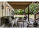Charming covered patio with comfortable seating and views of the landscaped backyard at 221 Brooke Dr., Alpharetta, GA 30009