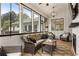 A bright sunroom features a fireplace and a view at 221 Brooke Dr., Alpharetta, GA 30009