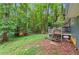 The backyard is wooded and features a deck that can be accessed by stairs at 4585 Muirwood Cir, Powder Springs, GA 30127