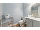 This bathroom features blue walls, a sink and vanity, a toilet, and tiled floors at 4585 Muirwood Cir, Powder Springs, GA 30127