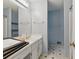 This bathroom features a white vanity, a large mirror, a tub and shower combination, and patterned tile floors at 4585 Muirwood Cir, Powder Springs, GA 30127