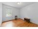 Simple bedroom with hardwood floors and neutral wall color at 4585 Muirwood Cir, Powder Springs, GA 30127