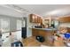 Kitchen with ample cabinet space, stainless steel refrigerator, and connection to living space at 4585 Muirwood Cir, Powder Springs, GA 30127