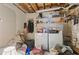 This laundry room has a washer, dryer, and shelves for storage, perfect for completing laundry tasks at 4585 Muirwood Cir, Powder Springs, GA 30127