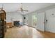 Bright living room featuring a fireplace, ceiling fan, and natural light at 4585 Muirwood Cir, Powder Springs, GA 30127