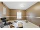This room features neutral-toned walls and floors, and a window with natural light at 4585 Muirwood Cir, Powder Springs, GA 30127