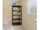 This room features a black plastic shelving unit and a window with natural light at 4585 Muirwood Cir, Powder Springs, GA 30127