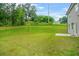 Spacious backyard featuring green grass, mature trees, and a patio area, ideal for relaxing and entertaining at 603 River Gardens Se Dr, Atlanta, GA 30354