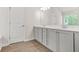 Bathroom featuring gray cabinets, double sinks, and wood-look floors at 603 River Gardens Se Dr, Atlanta, GA 30354